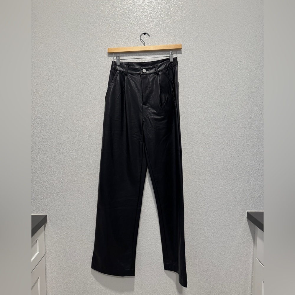 Women Black leather-like pants size XS. I believe they are vegan leather